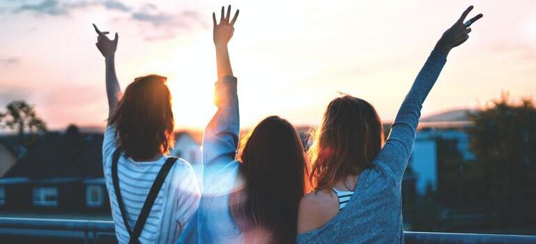 three people with their hands up