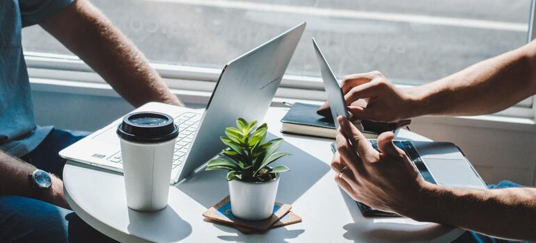 two people with their laptops